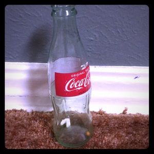 Used Coca Cola bottle with gum and popcorn in it
